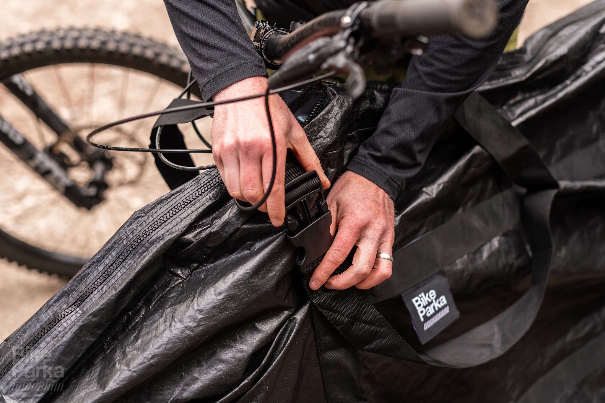 Bike being placed into BikeParka RoughSac heavy-duty bike storage bag